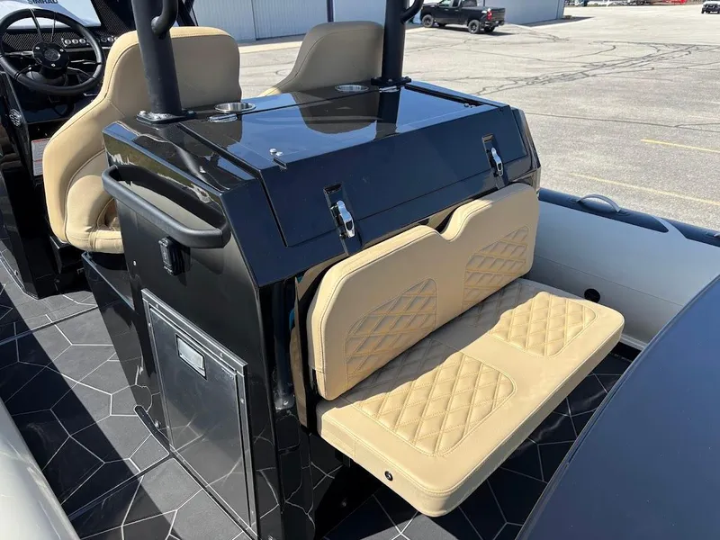 Slide: The Image of 2025 Highfield Sport 900 boat interior with beige quilted seating and sleek black console. - 19