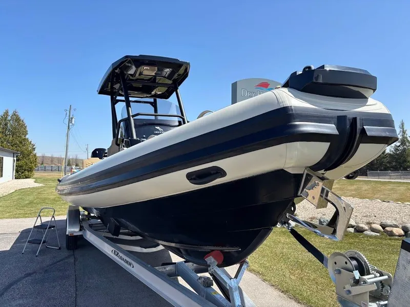 Slide: The Image of 2025 Highfield Sport 900 boat on trailer, displayed outdoors under clear blue sky. - 21