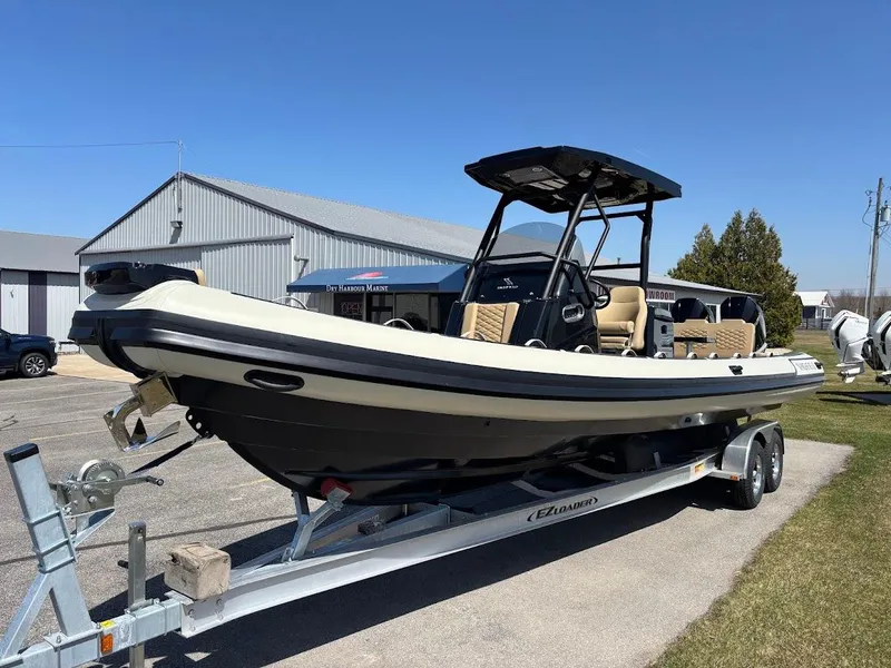 Slide: The Image of 2025 Highfield Sport 900 boat on trailer, parked outdoors under clear blue sky. - 22