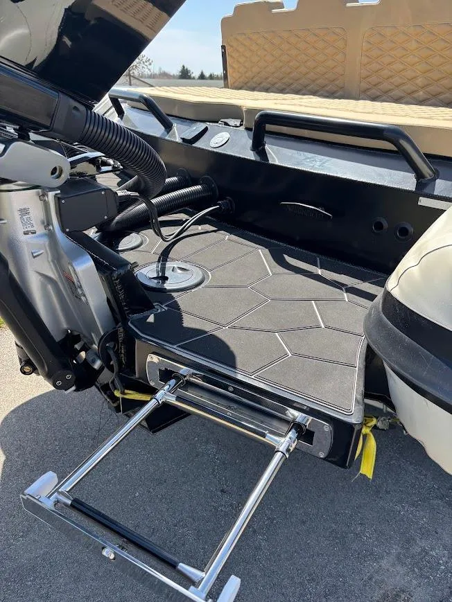 Slide: The Image of 2025 Highfield Sport 900 boat with a retractable ladder and sleek deck design. - 3