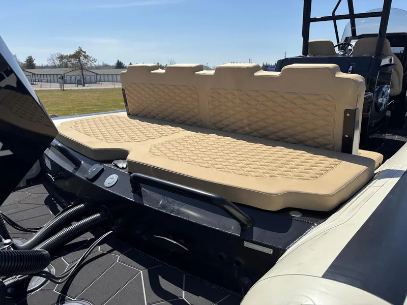 Slide: The Image of 2025 Highfield Sport 900 boat with beige quilted seating, outdoor setting. - 4