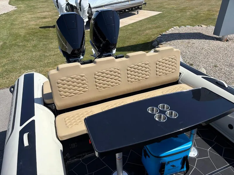 Slide: The Image of 2025 Highfield Sport 900 boat interior with beige seating and black table. - 5