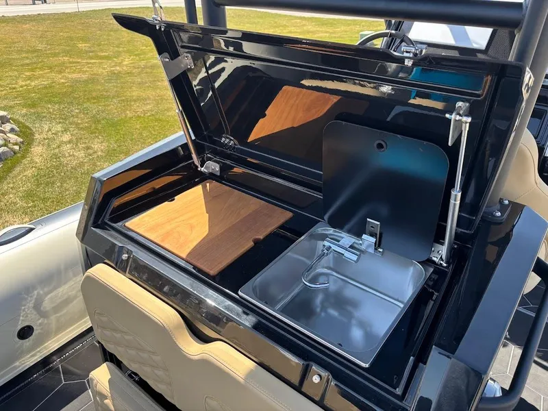 Slide: The Image of Highfield Sport 900 (2025) boat with open kitchenette, featuring a sink and cutting board. - 7