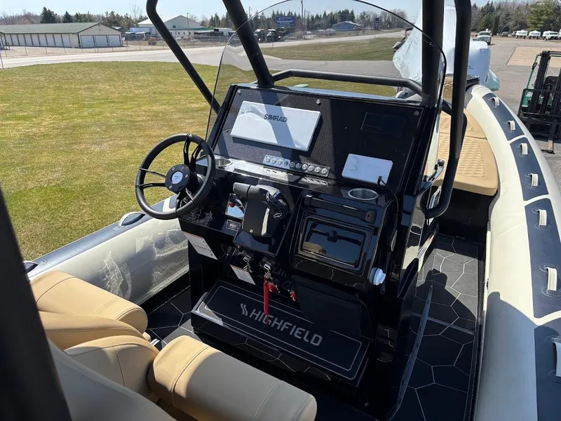Slide: The Image of 2025 Highfield Sport 900 boat interior with steering console and seating. - 9