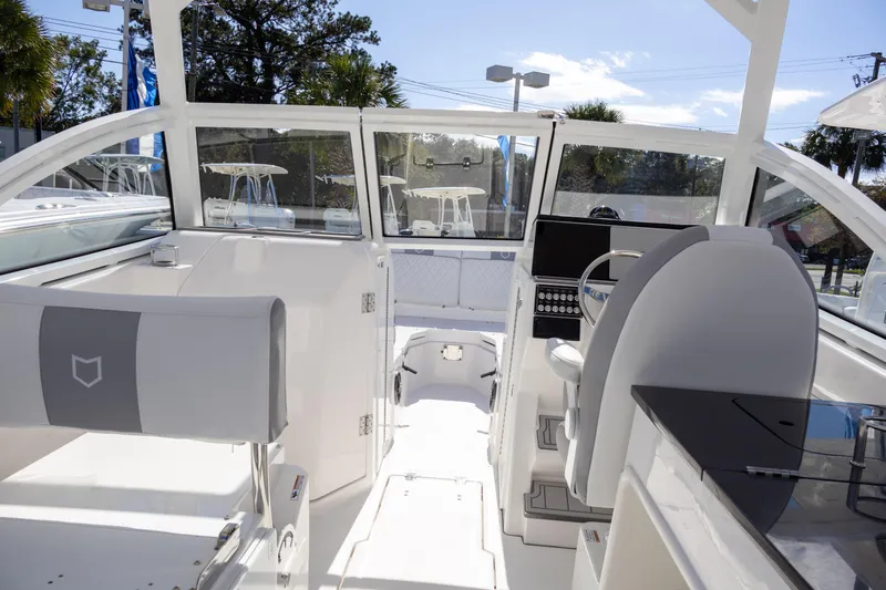 Slide: The Image of Interior view of 2025 Sea Fox 268 Traveler boat, featuring modern helm and seating. - 11