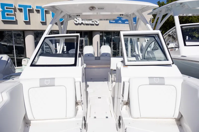 Slide: The Image of 2025 Sea Fox 268 Traveler boat with open seating, displayed at a sales showroom. - 14