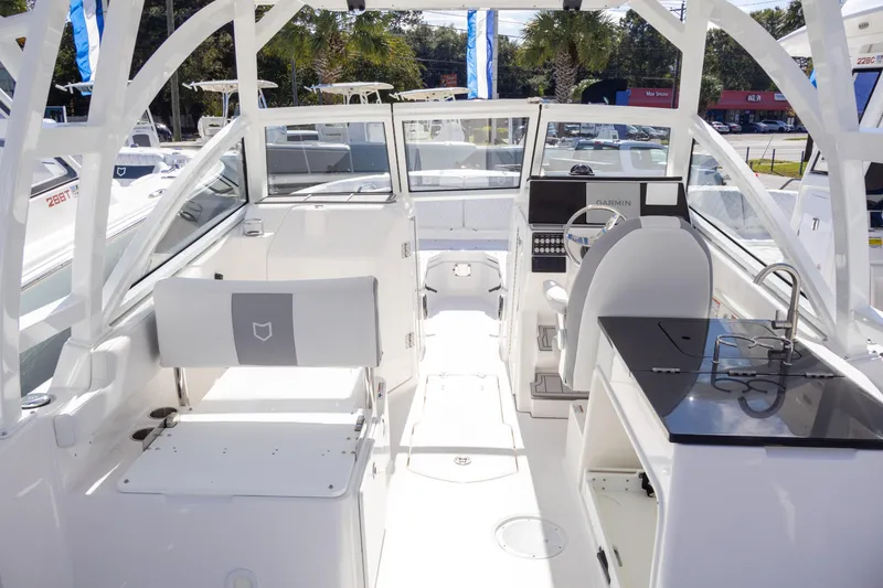 Slide: The Image of 2025 Sea Fox 268 Traveler boat interior with seating, helm, and kitchenette. - 8