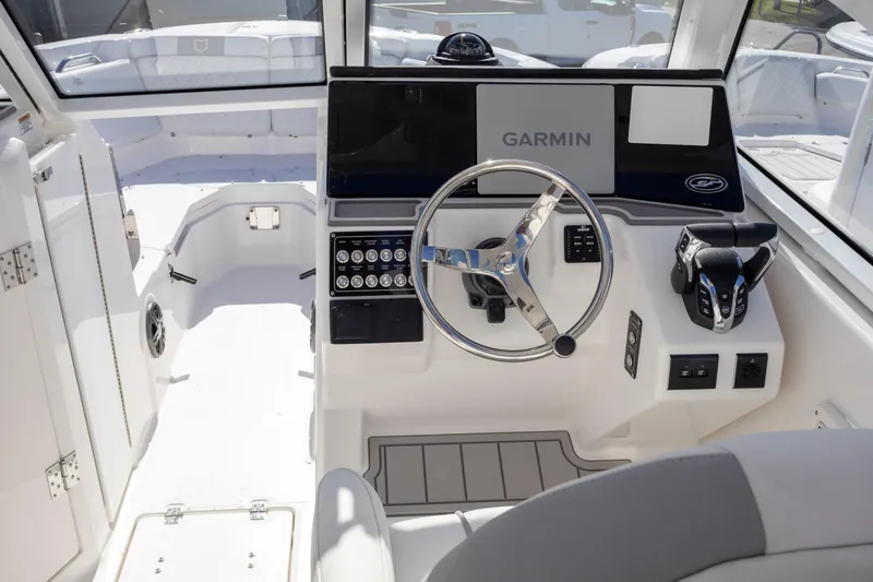 Slide: The Image of 2025 Sea Fox 268 Traveler boat cockpit with Garmin navigation system and modern controls. - 9