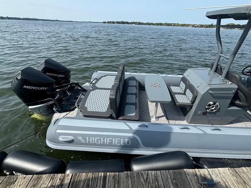 Slide: The Image of 2025 Highfield Sport 900 boat docked, featuring dual Mercury engines and sleek seating. - 1