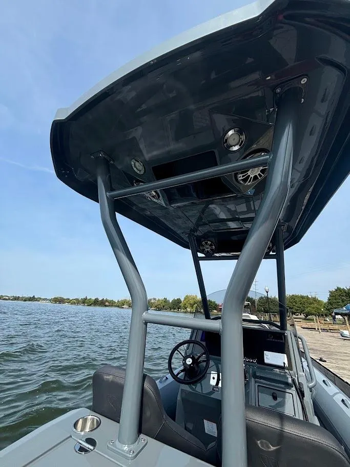 Slide: The Image of 2025 Highfield Sport 900 boat with sleek design and sturdy canopy on a calm lake. - 3