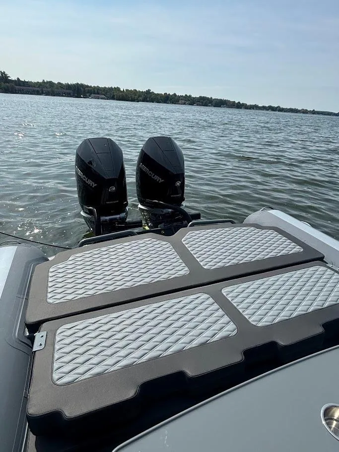 Slide: The Image of Highfield Sport 900 boat with dual Mercury engines on a sunny lake, 2025 model. - 5