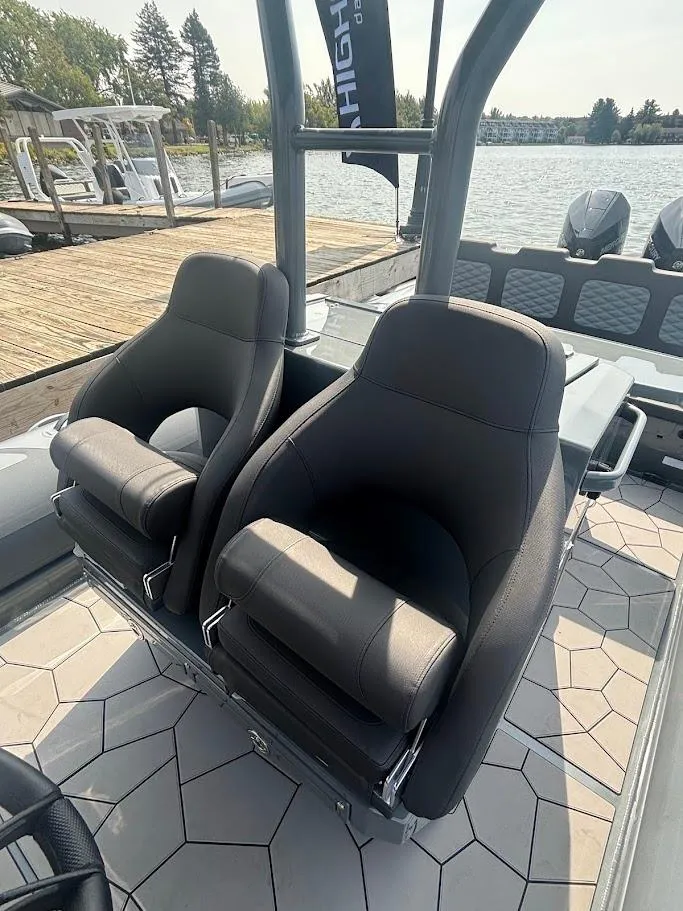 Slide: The Image of 2025 Highfield Sport 900 boat interior with two sleek, modern seats by the water. - 6