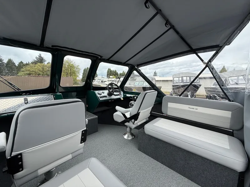 Slide: The Image of Interior of 2025 Thunder Jet 210 Luxor boat, featuring modern seating and steering area. - 13