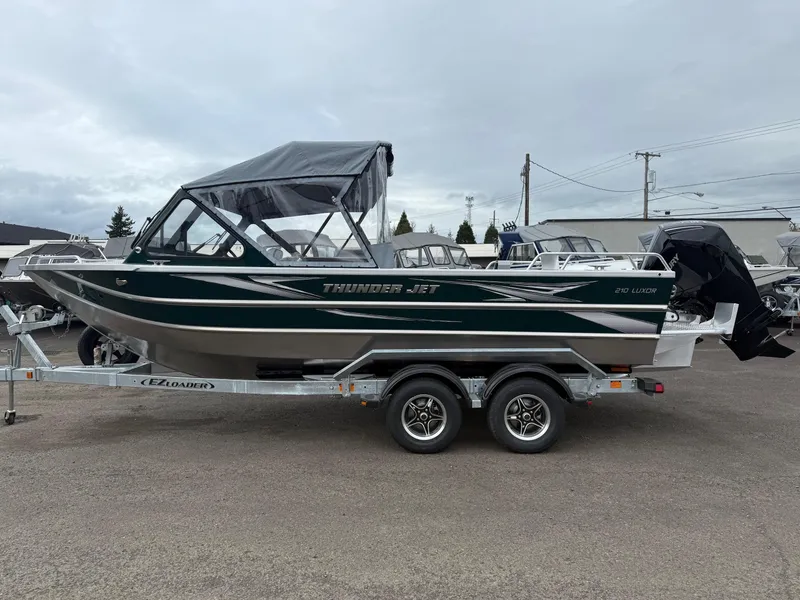 Slide: The Image of 2025 Thunder Jet 210 Luxor boat on trailer, parked outdoors. - 5