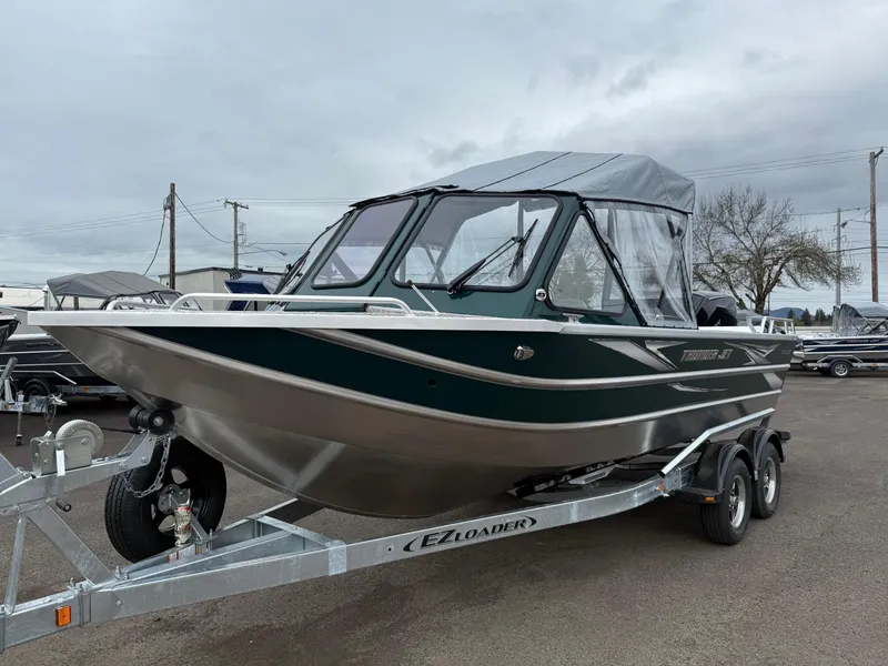 Slide: The Image of 2025 Thunder Jet 210 Luxor boat on trailer, parked outdoors under cloudy sky. - 6