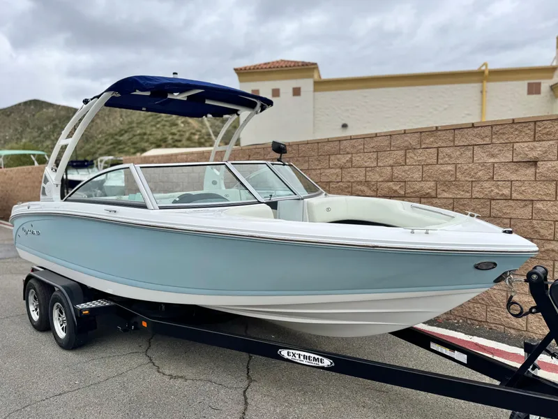 Slide: The Image of 2020 Cobalt 220S boat on trailer, light blue hull, parked outdoors. - 1