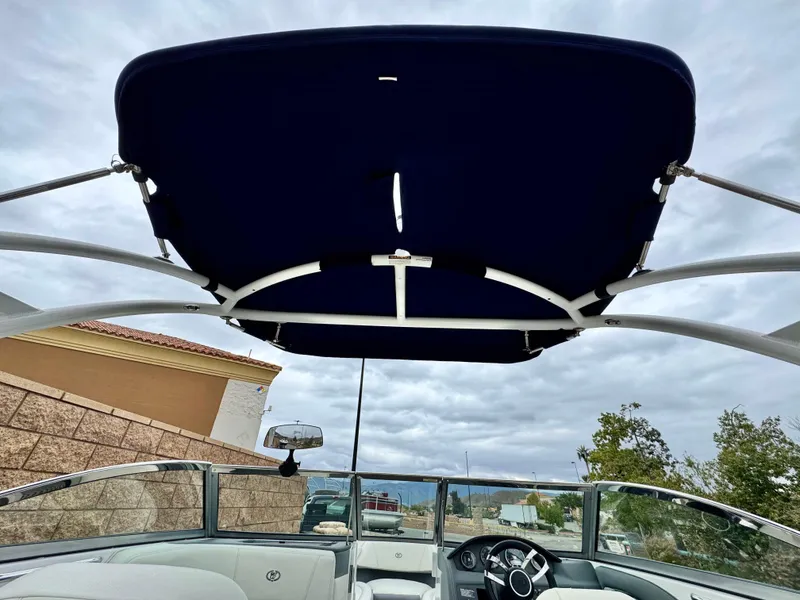 Slide: The Image of 2020 Cobalt 220S boat with blue canopy and sleek interior design. - 10