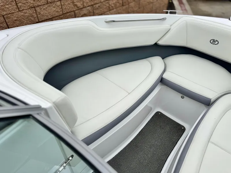 Slide: The Image of 2020 Cobalt 220S boat interior with white cushioned seating and sleek design. - 13