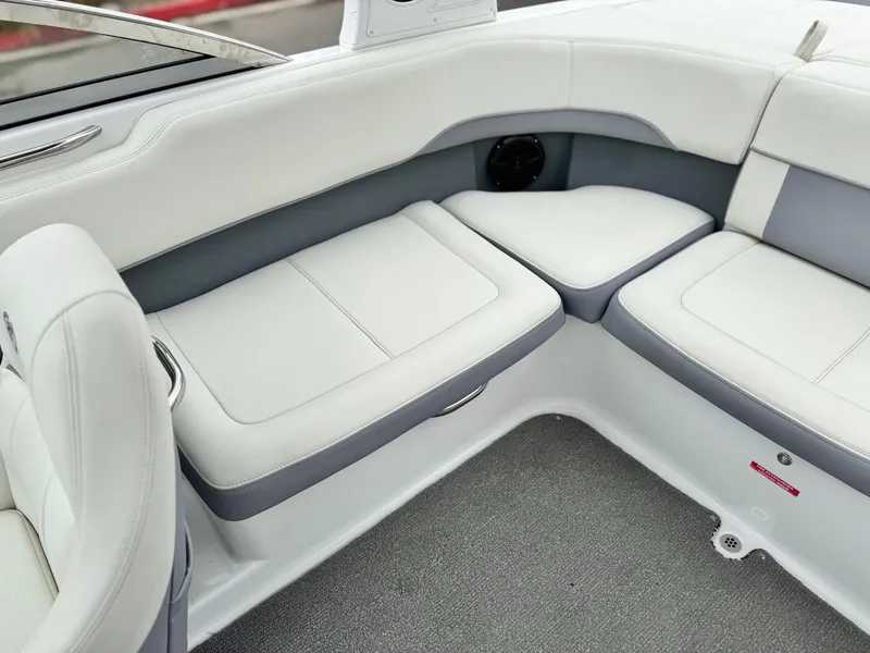 Slide: The Image of 2020 Cobalt 220S boat interior with white and gray cushioned seating. - 18