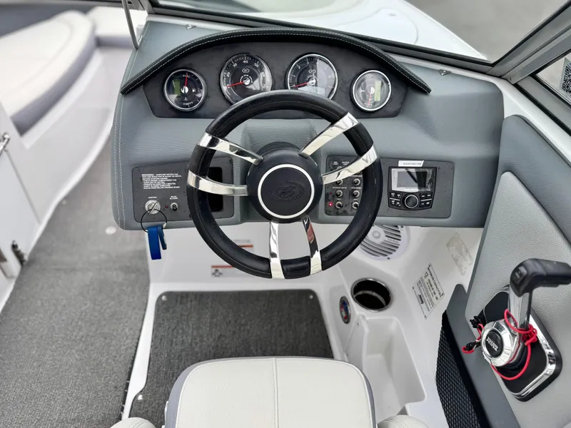 Slide: The Image of Cockpit of 2020 Cobalt 220S boat with steering wheel and control panel. - 27
