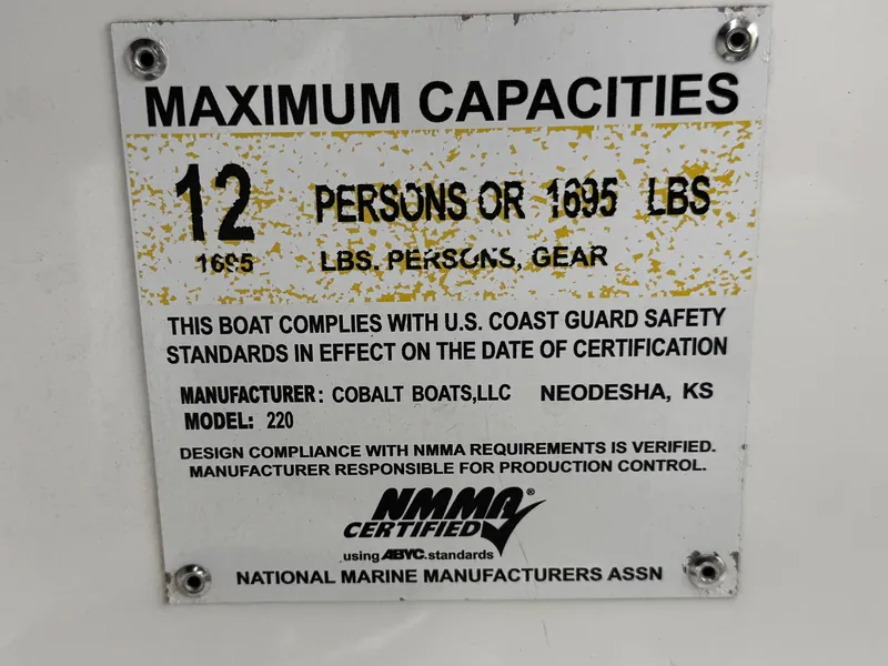 Slide: The Image of Capacity plate for 2020 Cobalt 220S boat, 12 persons or 1695 lbs, NMMA certified. - 31