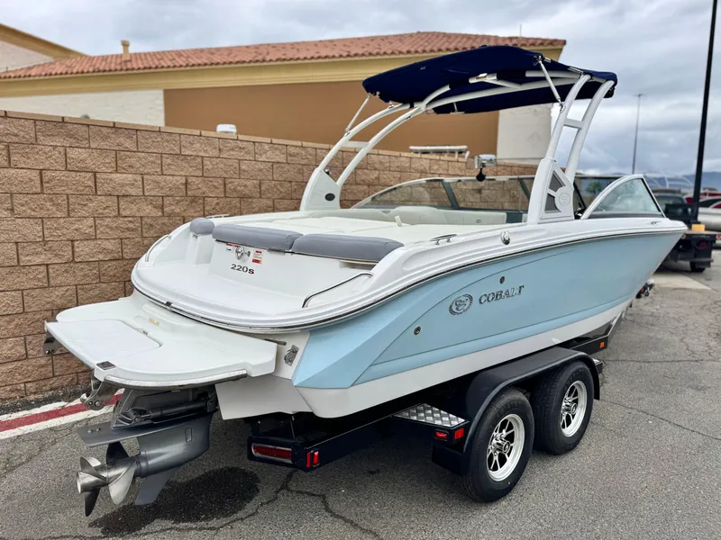 Slide: The Image of 2020 Cobalt 220S boat on trailer, parked outdoors, featuring sleek design and blue accents. - 5