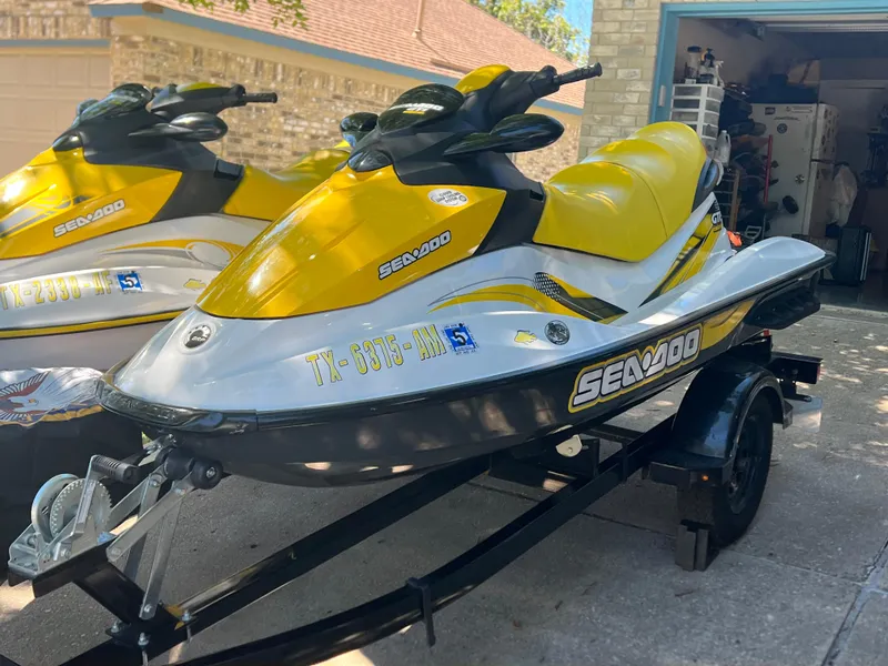 Slide: The Image of 2007 Sea-Doo GTI 130 jet ski with yellow and silver design on a trailer. - 3
