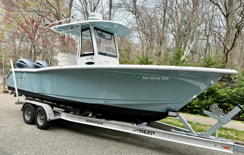 Slide: The Image of 2019 Sea Hunt Gamefish 25 boat on trailer, parked outdoors. - 0