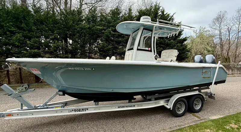Slide: The Image of 2019 Sea Hunt Gamefish 25 boat on trailer, parked outdoors. - 1