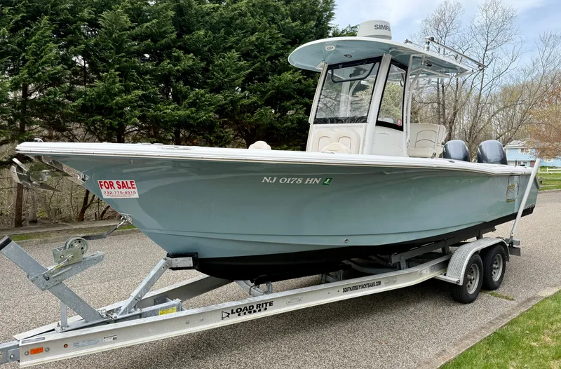 Slide: The Image of 2019 Sea Hunt Gamefish 25 boat on trailer, for sale, parked outdoors. - 2
