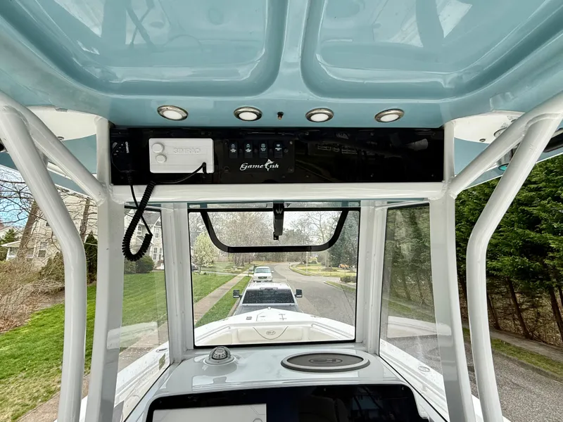 Slide: The Image of 2019 Sea Hunt Gamefish 25 boat console with overhead electronics and controls. - 21