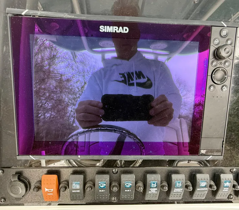 Slide: The Image of Simrad display on 2019 Sea Hunt Gamefish 25 boat dashboard with control switches. - 23
