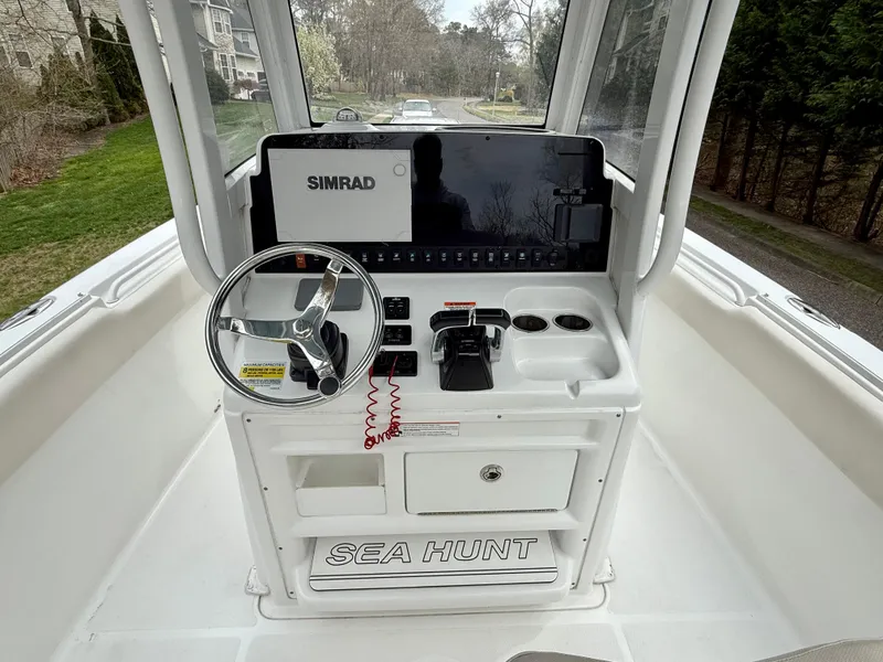 Slide: The Image of 2019 Sea Hunt Gamefish 25 helm with Simrad display and steering wheel. - 24