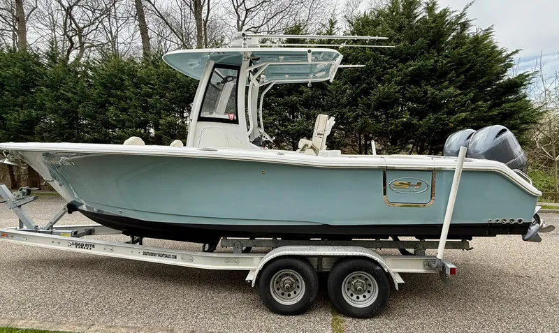 Slide: The Image of 2019 Sea Hunt Gamefish 25 boat on trailer, parked outdoors. - 27