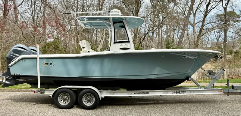 Slide: The Image of 2019 Sea Hunt Gamefish 25 boat on trailer, parked outdoors. - 34