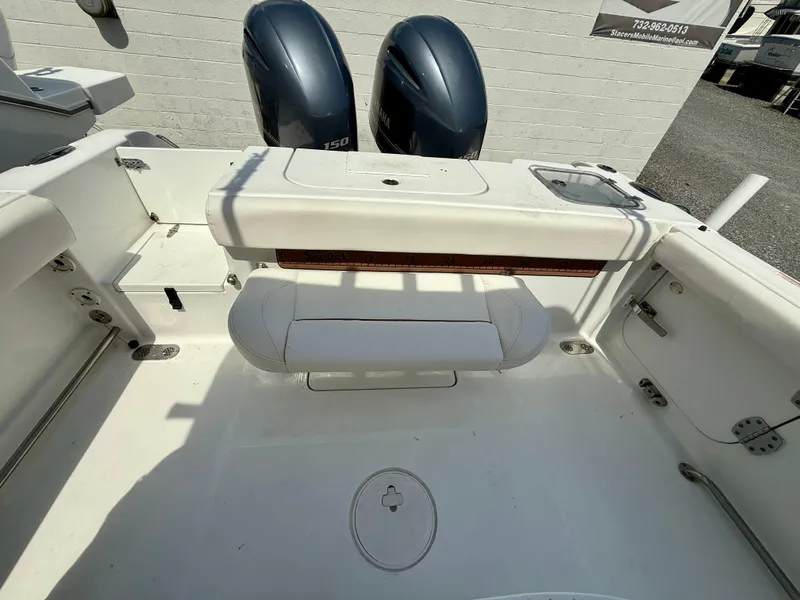 Slide: The Image of 2019 Sea Hunt Gamefish 25 boat interior with dual engines and seating area. - 37