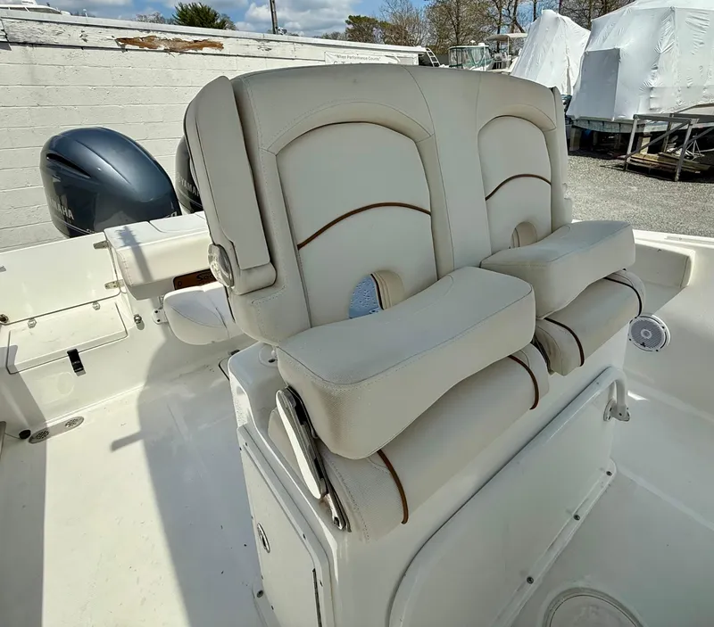 Slide: The Image of 2019 Sea Hunt Gamefish 25 boat with dual cushioned seats and outboard motor. - 39
