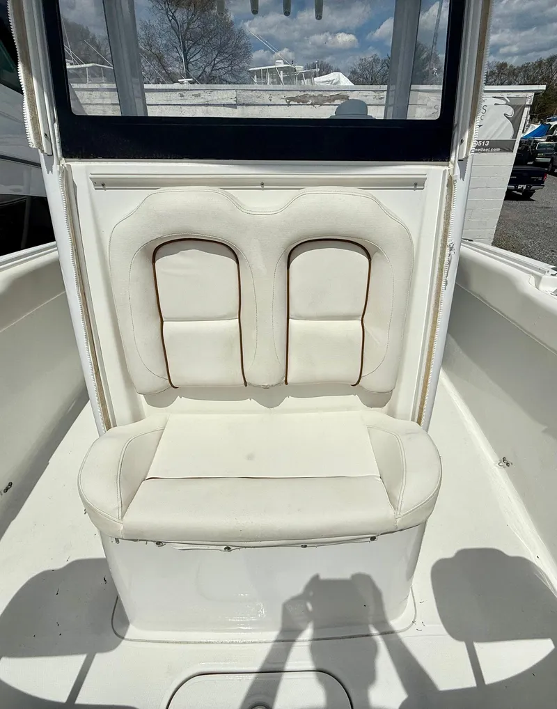Slide: The Image of 2019 Sea Hunt Gamefish 25 boat interior with white cushioned seating. - 40