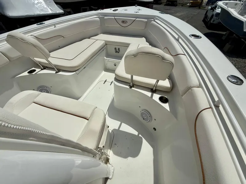 Slide: The Image of 2019 Sea Hunt Gamefish 25 boat interior with cushioned seating and storage compartments. - 45