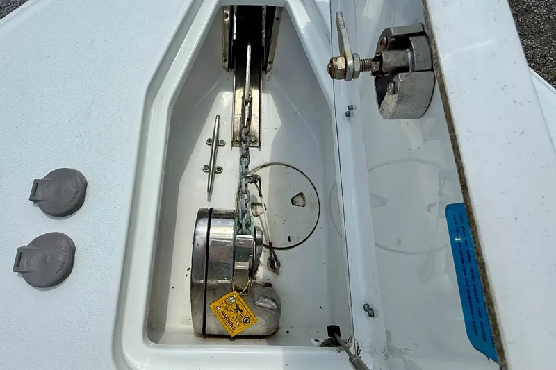 Slide: The Image of Anchor compartment of 2019 Sea Hunt Gamefish 25 boat, featuring chain and winch system. - 46