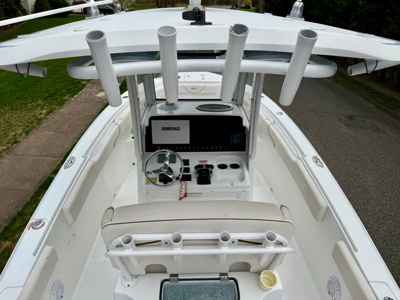 Slide: The Image of 2019 Sea Hunt Gamefish 25 boat cockpit with steering wheel and rod holders. - 5