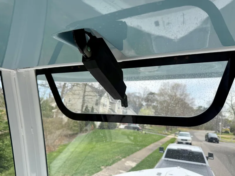 Slide: The Image of 2019 Sea Hunt Gamefish 25 windshield wiper detail, showcasing exterior view and street. - 9