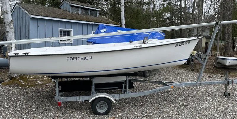 Slide: The Image of Sailboat on trailer, Precision 15 model, 2012, parked near a blue shed. - 0