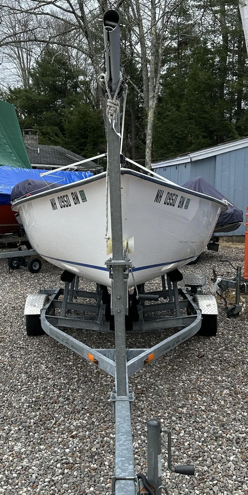 Slide: The Image of Small sailboat on trailer, Precision 15 model, 2012, parked on gravel with trees in background. - 10