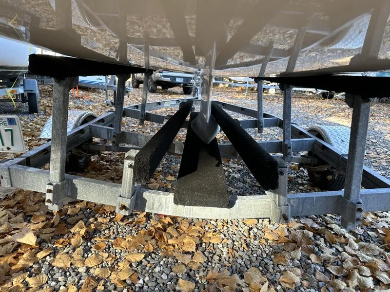 Slide: The Image of Boat trailer with metal frame and black supports, surrounded by autumn leaves. - 11