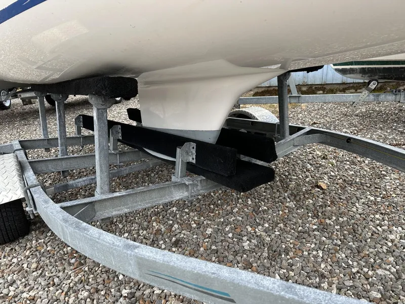 Slide: The Image of Boat trailer with Precision 15 sailboat keel, 2012 model, on gravel surface. - 9