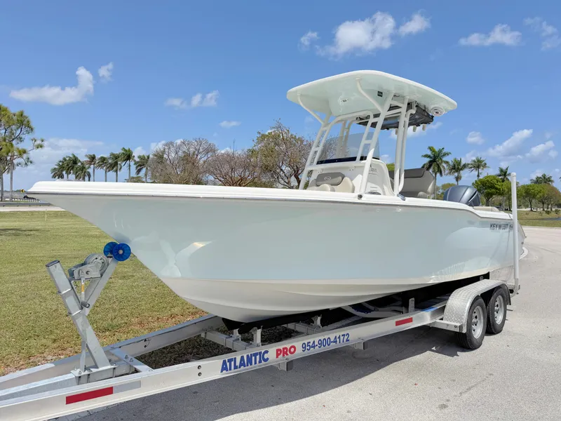 Slide: The Image of 2023 Key West 239 FS boat on trailer under clear blue sky. - 1