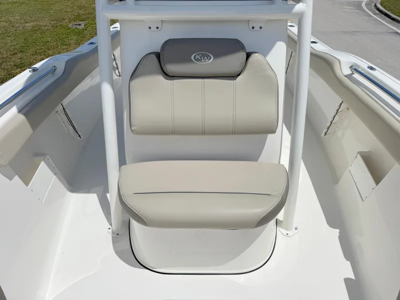 Slide: The Image of 2023 Key West 239 FS boat seating area with beige cushions and KW logo. - 10