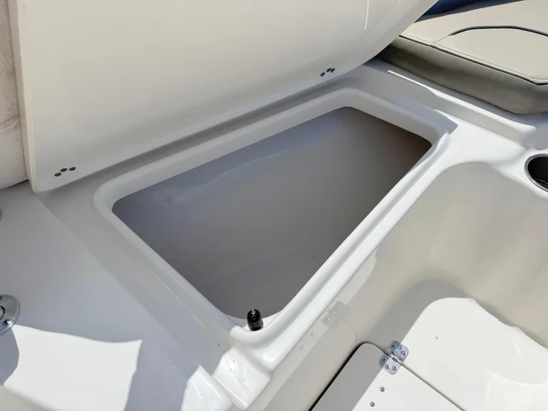 Slide: The Image of 2023 Key West 239 FS boat storage compartment, open lid, white interior, spacious design. - 12
