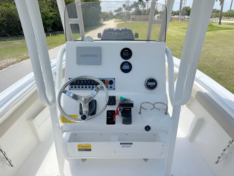 Slide: The Image of 2023 Key West 239 FS boat console with Garmin navigation and steering wheel. - 16